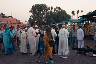 Rear view of people walking on street market