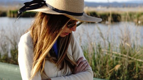 Side view of young woman in hat