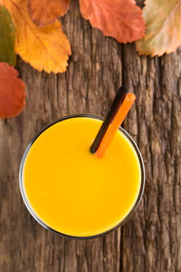 High angle view of yellow drink on table