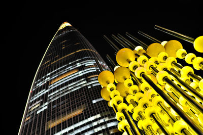 Low angle view of illuminated building against sky at night