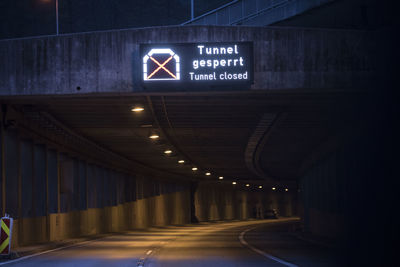 Illuminated road sign at night