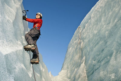 Woman climbing on the fjallsjökull glacier in iceland