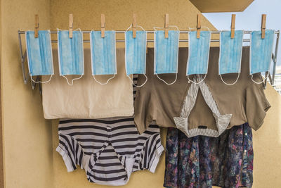 Clothes drying on clothesline against wall