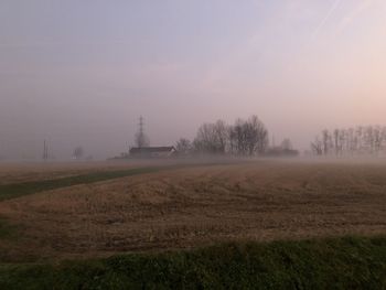 Scenic view of field against sky at foggy weather