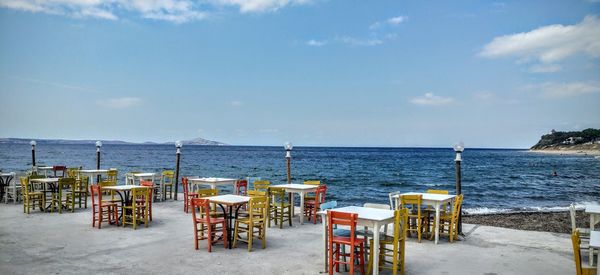 Empty chairs and tables at beach