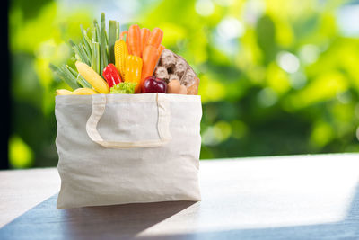 Close-up of food in shopping bag on table