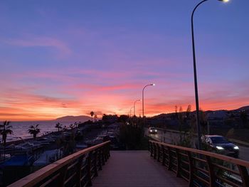 Street against sky during sunset