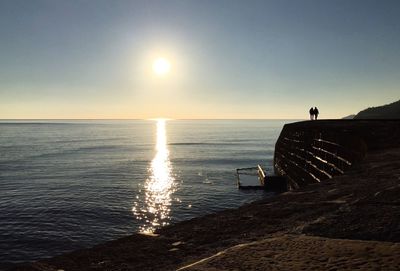 Scenic view of sea against clear sky during sunset