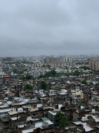 High angle view of buildings in city against sky