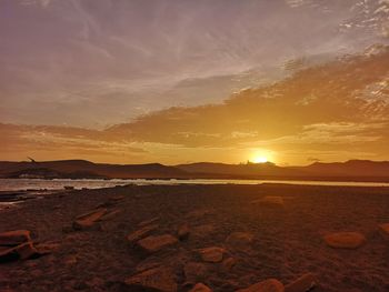 Scenic view of beach against sky during sunset