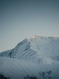 Scenic view of snowcapped mountains against clear sky