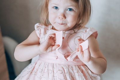 Portrait of cute girl in dress at home