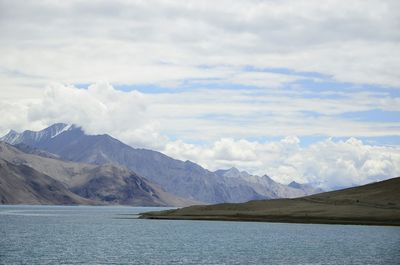 Scenic view of mountains against cloudy sky