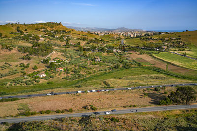 High angle view of townscape by sea against sky