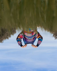 Woman paragliding against blue sky