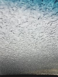 Full frame shot of raindrops on glass