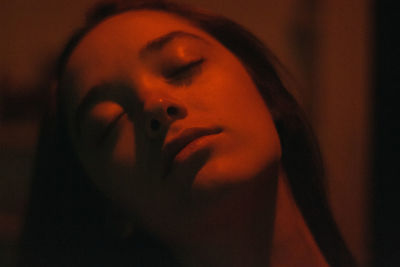 Close-up portrait of young woman at home