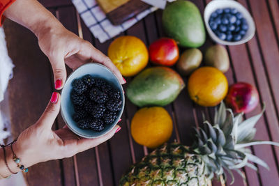 High angle view of woman holding fruits