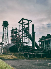 Low angle view of factory against sky