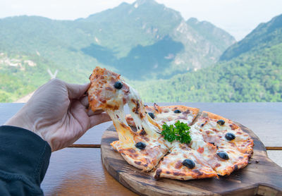 Cropped hand of woman holding food