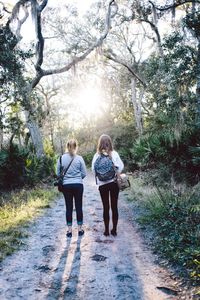 Rear view of woman walking on footpath