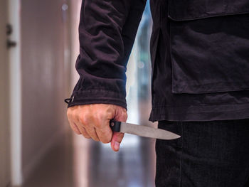 Midsection of man standing at home