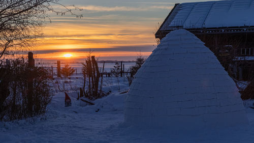 Scenic view of snow covered landscape during sunset