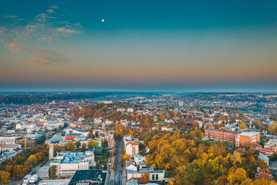 Aerial view of townscape against sky during sunset