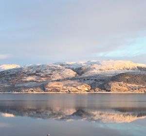 Scenic view of lake and mountains against sky