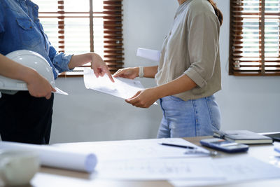 Midsection of businessman working at office