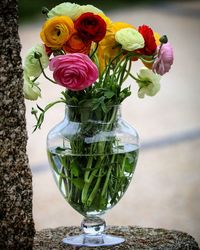 Close-up of rose bouquet in glass vase on table