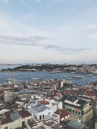 High angle view of townscape by sea against sky