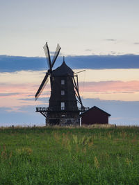 Wooden windmill at sunset