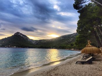 View of calm beach against mountain range