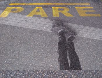 Man standing on road sign