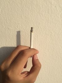 Human hand holding cigarette