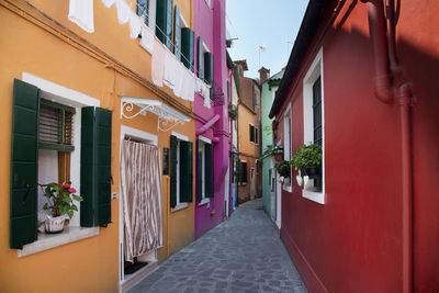 Narrow alley amidst buildings in city