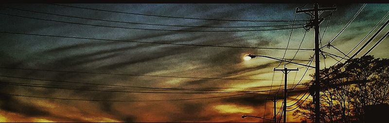 Low angle view of electricity pylon against sky