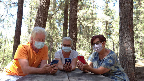 Man using mobile phone in forest