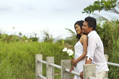 Young couple standing on field