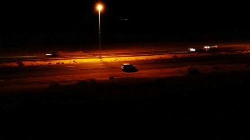 Airplane on road against sky at night