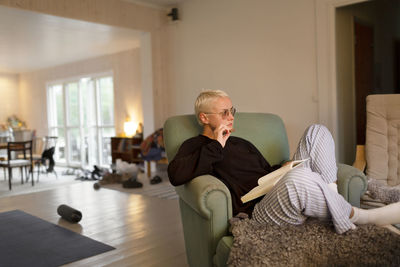 Woman sitting on armchair