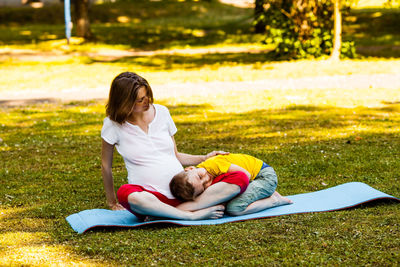 Rear view of women lying on grass