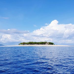 Scenic view of sea against blue sky