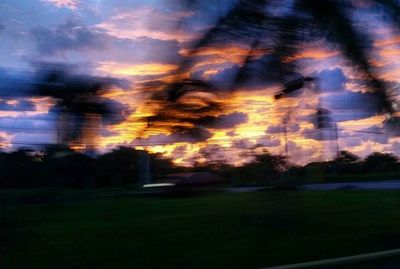 Defocused image of trees against sky at night