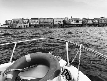 Boat sailing on sea against clear sky