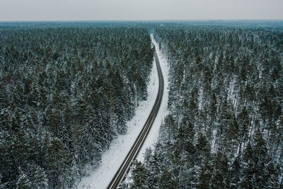 Aerial view of road amidst land against sky