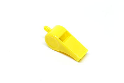 Close-up of yellow toy over white background