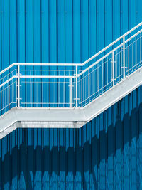 Low angle view of white staircase against blue wall
