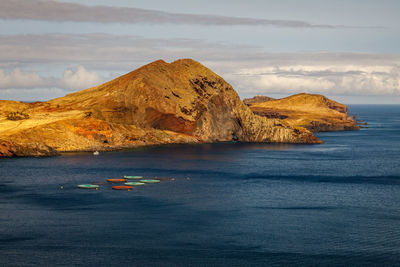 Rock formations in sea against sky